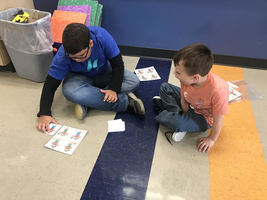 Mrs. Boland's Kindergarten Class Enjoying Mrs. Rambo's Fifth Grade Class Helping Them Learn